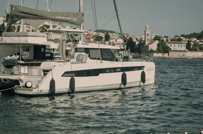 Luxury Leopard 50 catamaran moored in scenic Hvar harbor with cityscape backdrop.