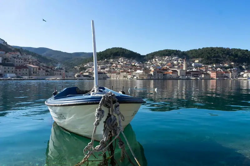a small boat tied to a dock in the water